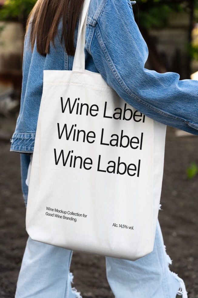 Tote bag mockup featuring wine label design in bold text, perfect for branding presentations. Ideal for designers focused on packaging and graphics.