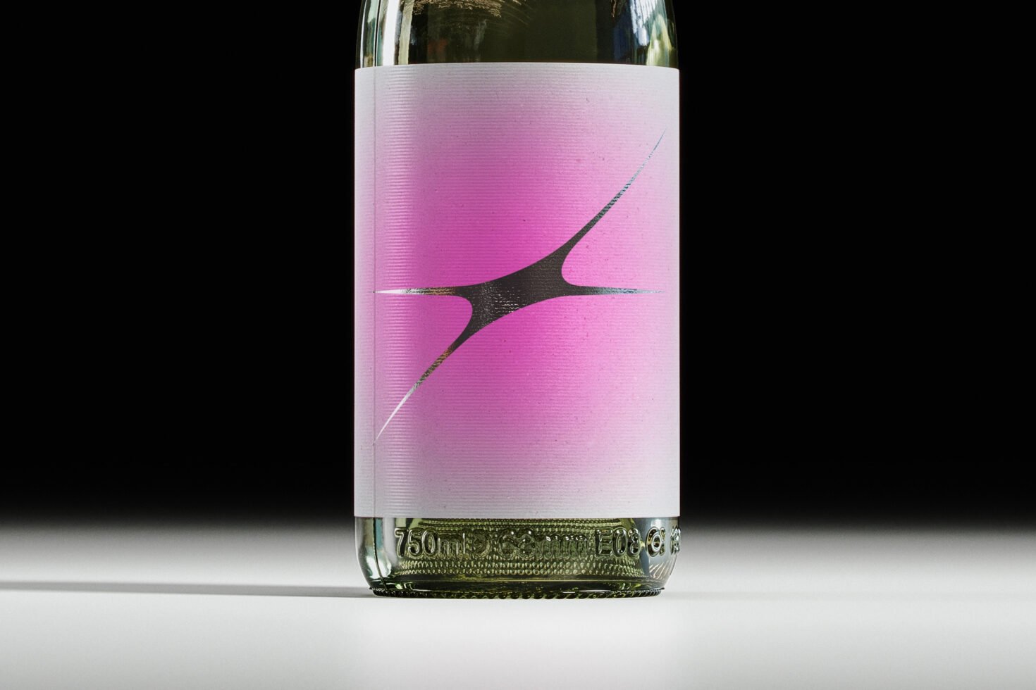 Mockup of a wine bottle with a pink and black abstract label against a black background ideal for showcasing branding and packaging designs.