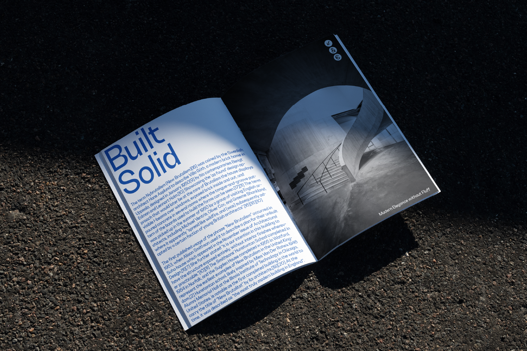 Open magazine mockup on asphalt with bold headline Built Solid on left page and black and white architectural photo on right. Ideal for design presentations