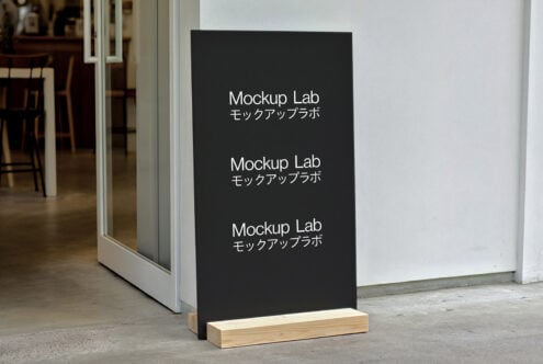 Outdoor black sign mockup for designers featuring text Mockup Lab in Japanese and English ideal for template display outside a modern cafe.