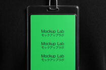 Plastic ID badge holder with bright green screen showing repeated text, hanging from metal chain