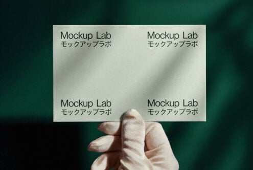 Hand holding a business card mockup with elegant Japanese text on green background. Ideal for graphic designers, branding, print templates, visual identity.