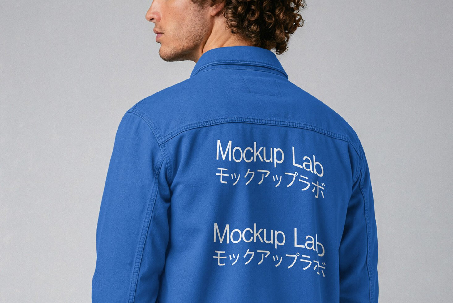 Designer in blue denim jacket with double Mockup Lab text on back. Perfect for apparel mockups, digital assets, fashion design, branding templates.