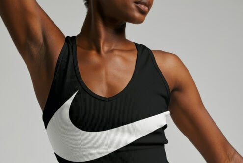 Close-up of a woman in a black sports top with a white logo design. Ideal for clothing mockups, fitness graphics, or activewear templates.