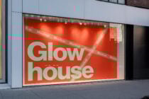 Storefront window mockup featuring bold typography on red background Glow house. Perfect for designers seeking realistic display graphics templates.