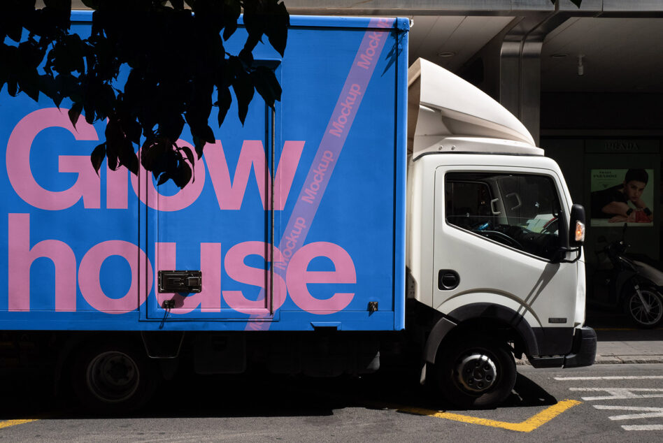 Blue truck panel with pink Glow house lettering silhouette leaves overhead
