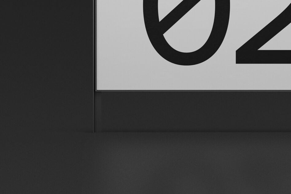 Close up of billboard screen showing partial black letter U against light gray