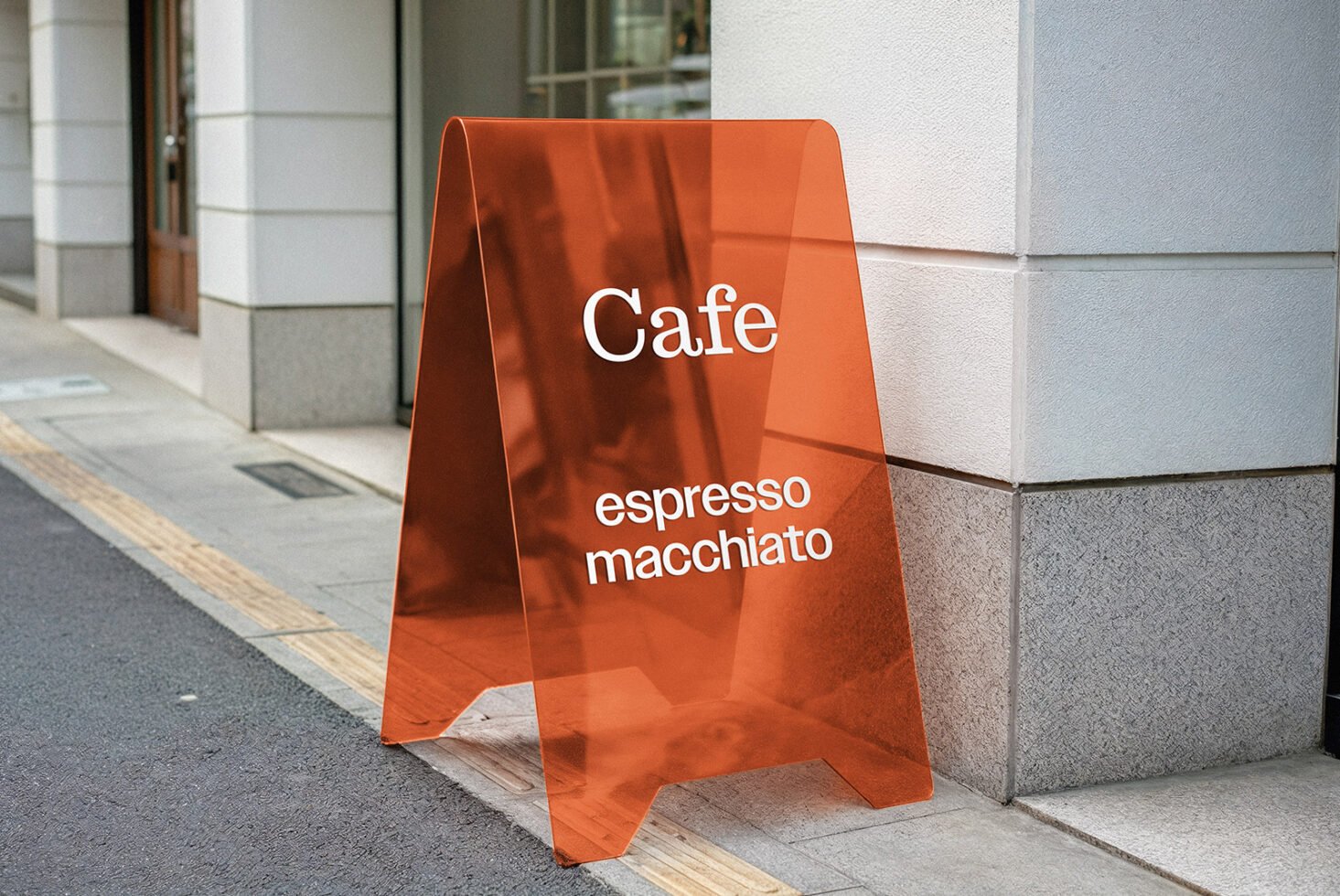 Red transparent cafe sign mockup on urban street, displaying espresso macchiato text, perfect for showcasing branding designs for graphic designers.