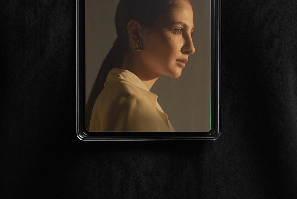 Overhead shot of rectangular badge frame displaying woman's profile portrait with natural lighting