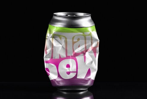 Crushed soda can on black background mockup showcasing bright colorful design perfect for branding and packaging presentations creative resources.