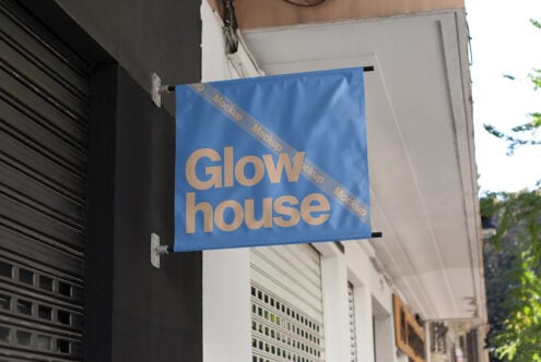 Blue hanging sign mockup with Glowhouse text, ideal for storefront branding. Urban setting enhances design aesthetics. Perfect for graphic designers.