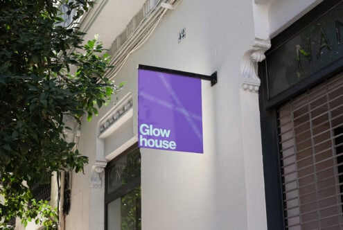 Purple storefront sign mockup for designers with Glow house text vibrant city setting suitable for graphic design templates digital asset marketplace.