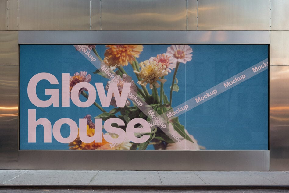 Street billboard showing Glow house text overlaid with fresh pink flowers on blue
