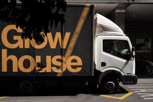 Truck mockup with large bold lettering Grow House. Urban setting, perfect for showcasing branding on vehicle graphics. Ideal for advertising design templates.