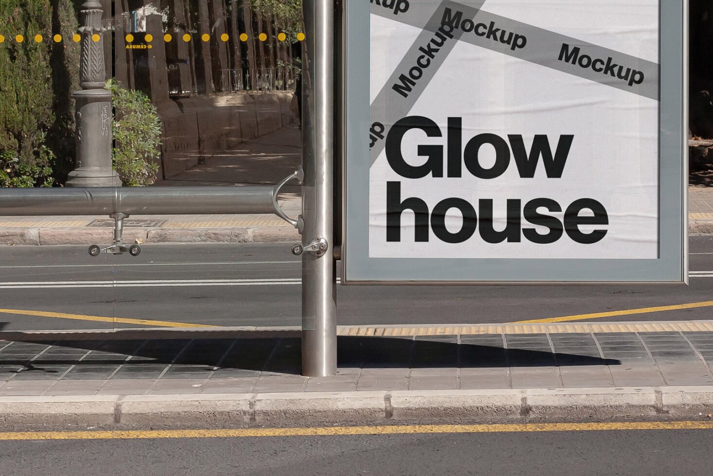 Outdoor poster mockup at a bus stop showcasing branding with large bold typography on a busy urban street. Ideal for designers seeking modern templates.