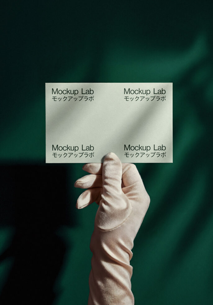Elegant gloved hand holding business card mockup with dark green background. Ideal for designers seeking minimalist templates, branding, stationery graphics.