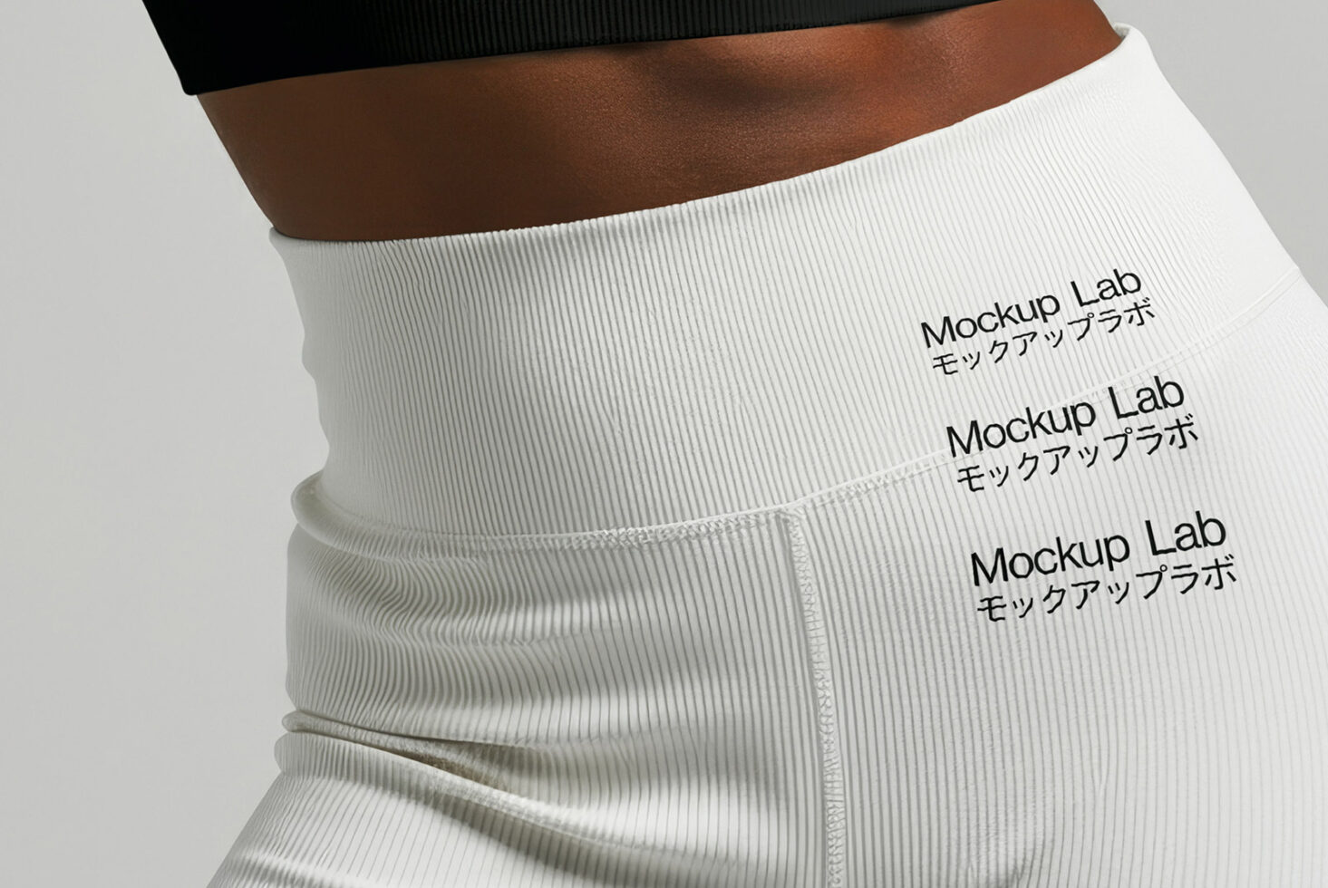 Close up of ribbed white sports bra with repeated text print pattern