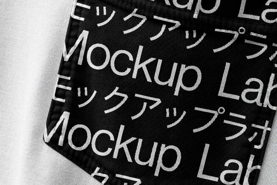 Black fabric with white Mockup Lab text overlaid showing textile pattern detail