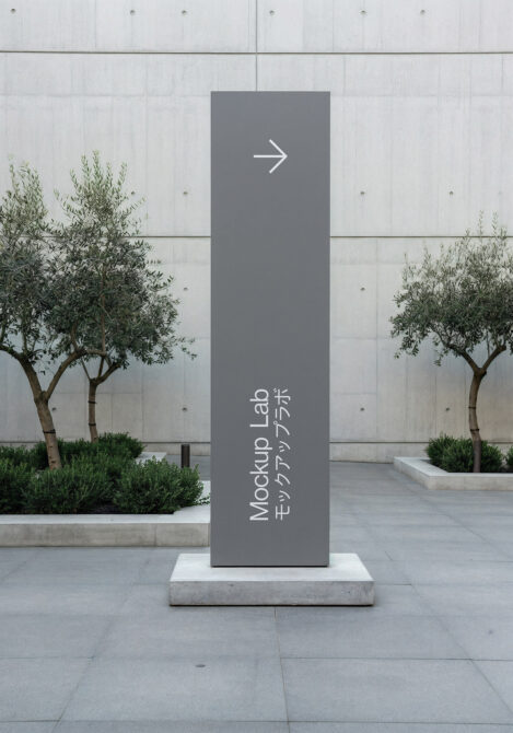 Tall wayfinding sign mockup with arrow symbol in modern urban setting