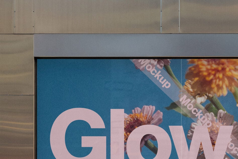 Street billboard with pink text reading Glow on blue background with colorful flowers
