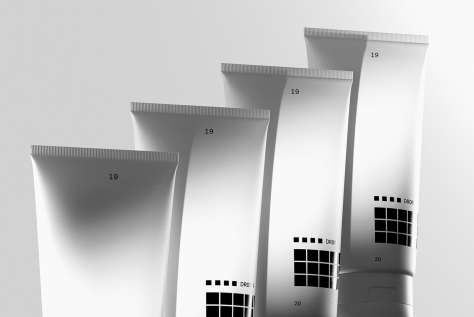 Minimalist grayscale tube mockups with label placement guides numbered