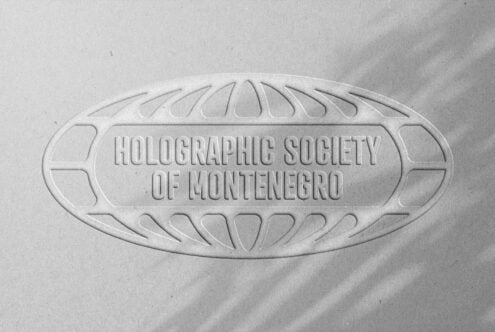 Embossed logo mockup with text Holographic Society of Montenegro. Oval design on textured paper. Ideal for branding and graphic designers.