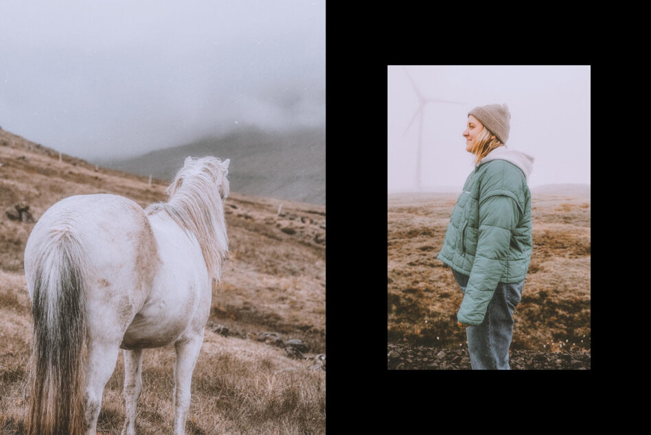White horse in misty hillside on left, woman in puffy jacket looking away on right