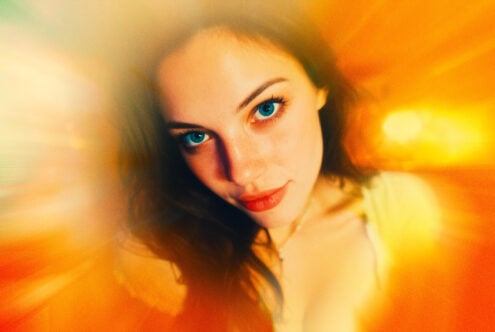 Close-up portrait of a woman with vibrant orange-yellow motion blur effect suitable for graphic design assets and creative projects in digital art.
