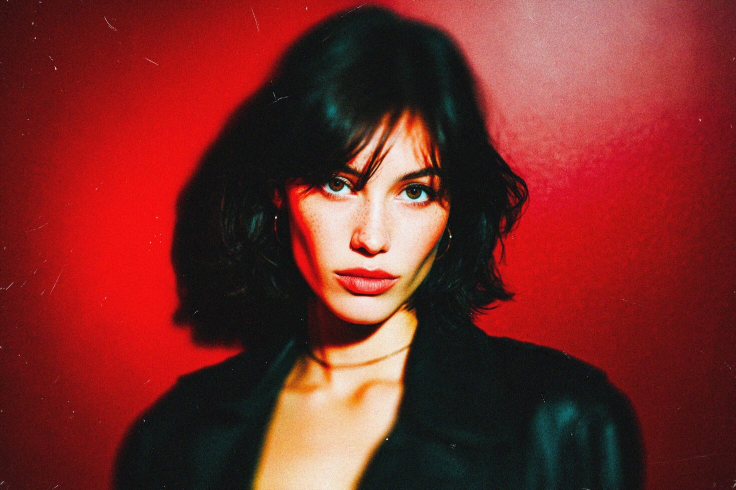 Woman with short dark hair against red backdrop, vibrant lighting, creative portrait, photography, graphic design asset for designers, artistic expression.