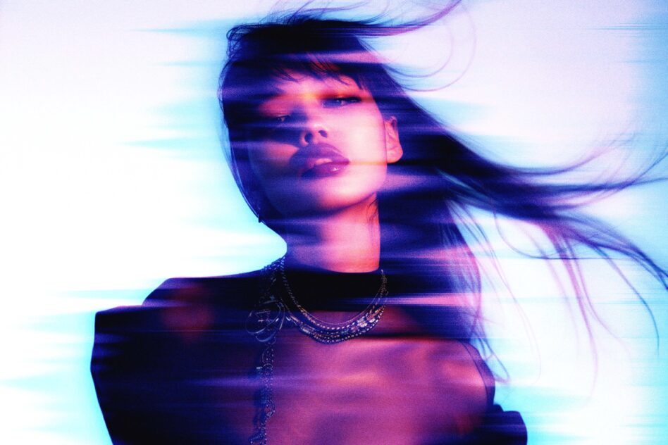 Person wearing chains with psychedelic glitch effect in neon pink purple blue