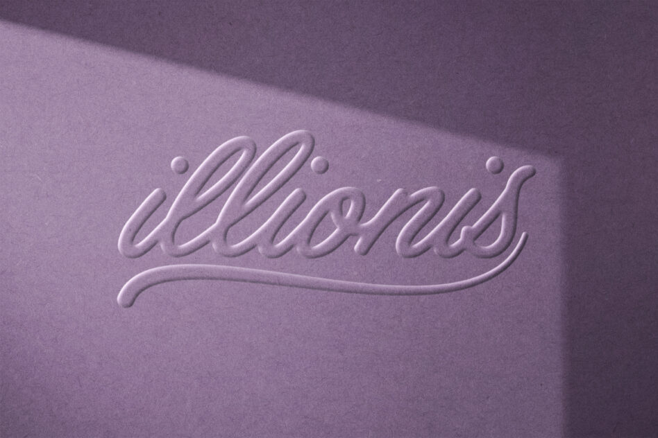 Embossed script text on matte purple surface with subtle shadow depth effect