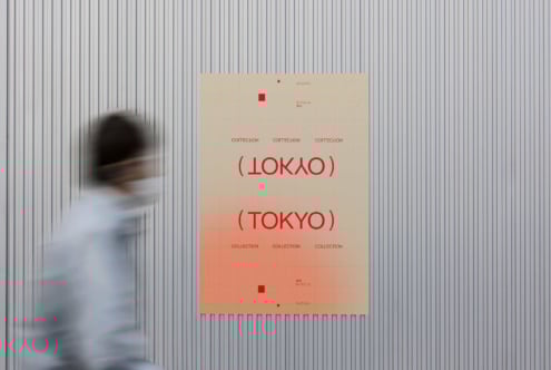 Poster mockup displayed on a ribbed wall features bold red text with Tokyo theme. A motion-blurred passerby adds dynamic context. Design resource.