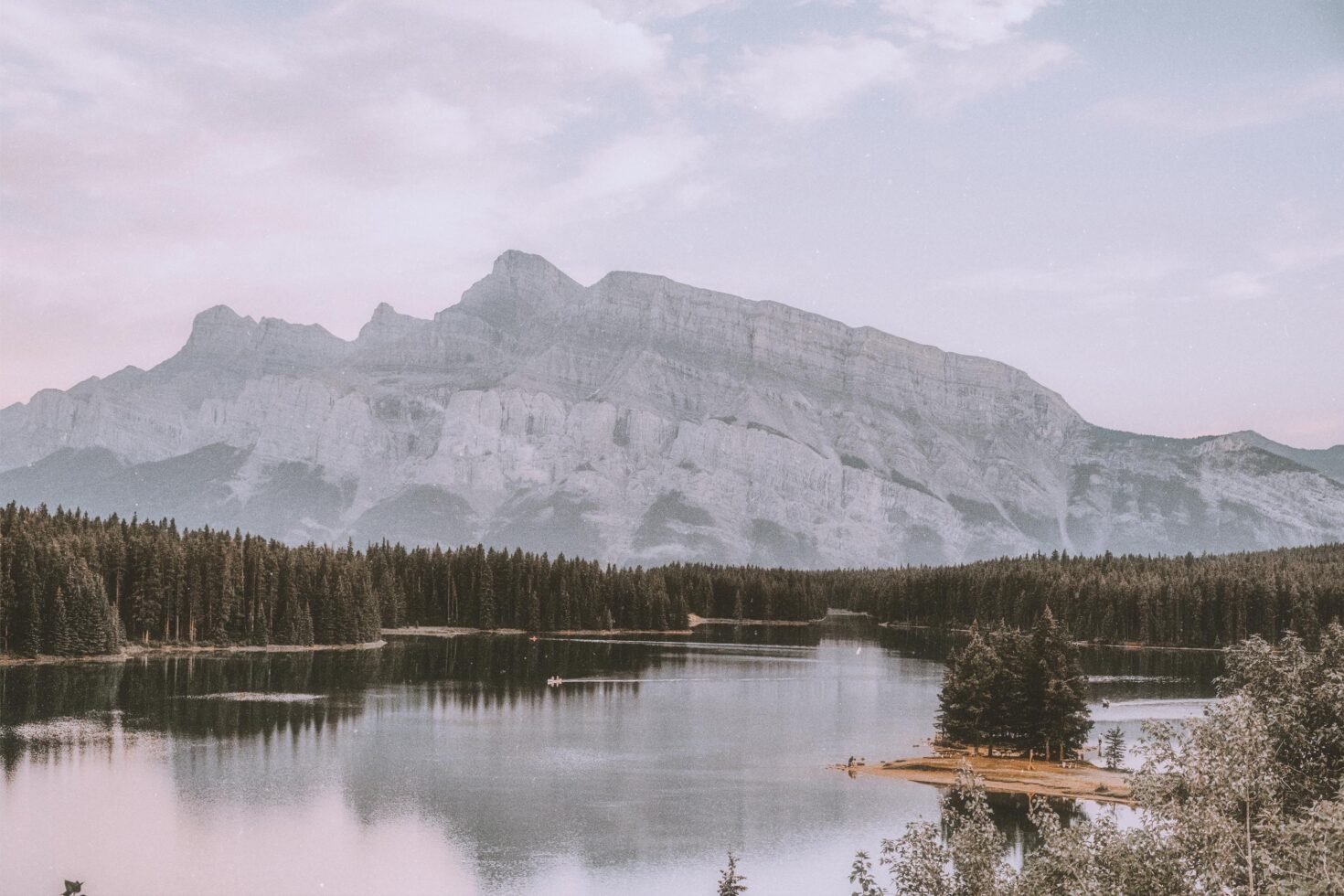 Vintage mountain landscape photo with serene lake and pine forest reflection, suitable for graphics designers and mockup resources, nature scenery.