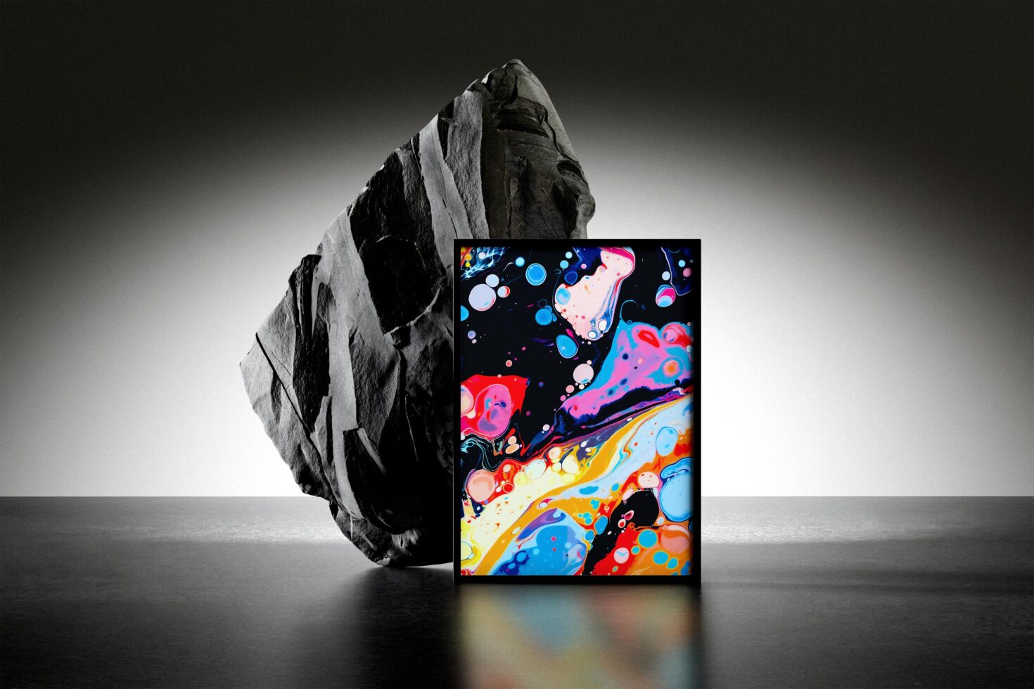 Abstract painting mockup with vibrant colors in front of large rock. Ideal for showcasing art prints or digital designs. Perfect for graphic designers.
