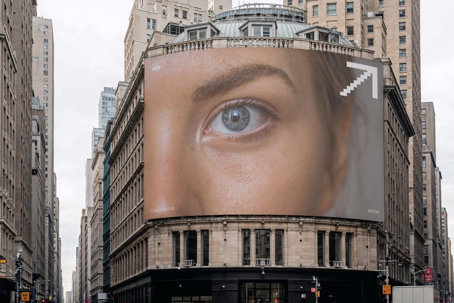 Large urban building with a massive eye billboard advertisement covering its facade, ideal for branding mockups and urban design templates.