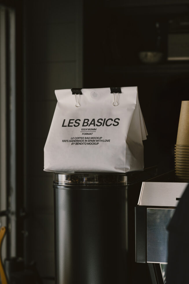 Coffee bag mockup with minimalistic design on display in a cafe setting ideal for branding designers seeking high-quality resources for packaging mockups.