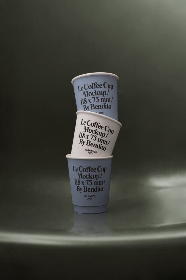 Three stacked paper coffee cups in white on dark olive surface
