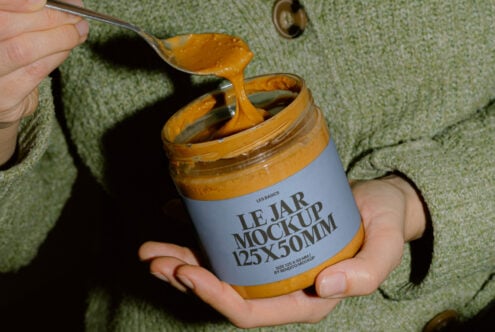 Close-up of jar mockup with golden spread dripping from spoon
