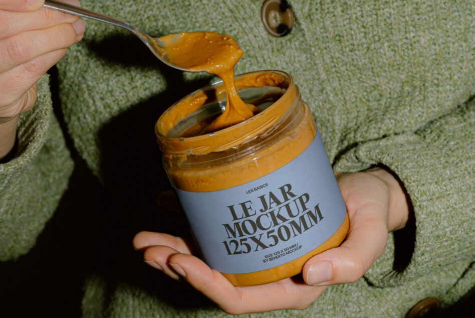 Close-up of jar mockup with golden spread dripping from spoon