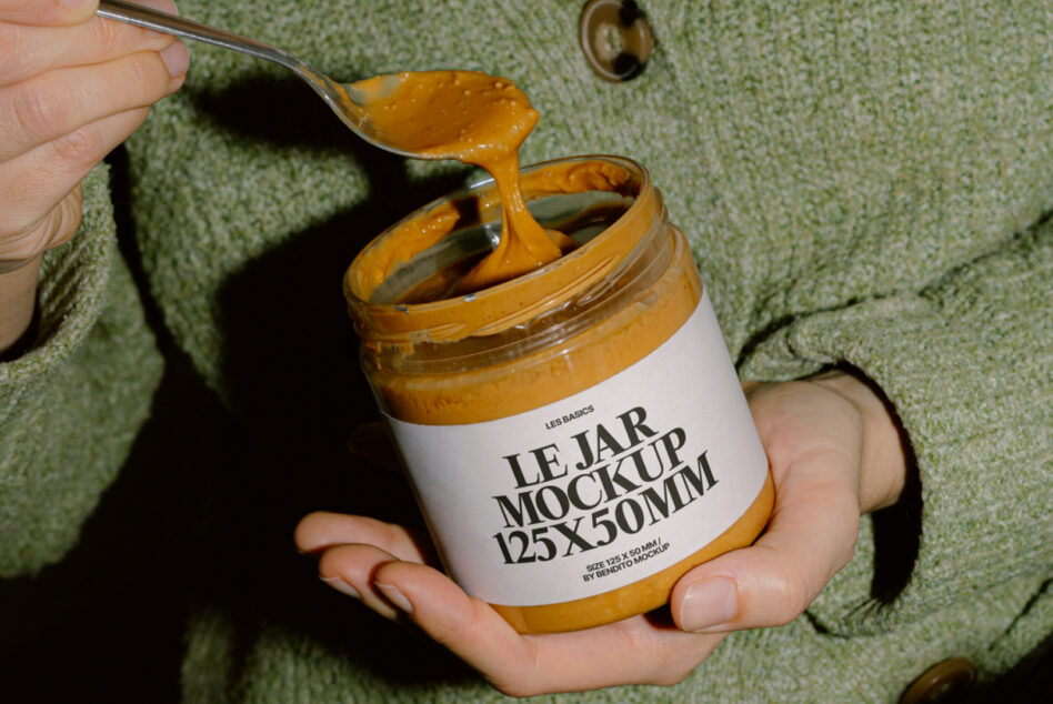 Close-up of jar mockup with golden spread dripping from spoon