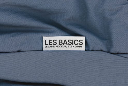 Fabric label mockup with text Les Basics on blue textured cloth background perfect for branding designers textile templates and graphic design assets.