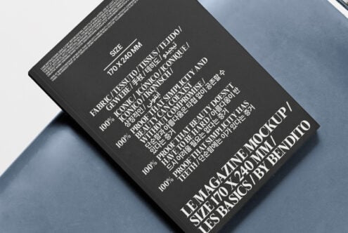 Black magazine cover mockup on a blue surface featuring diverse multilingual typography. Ideal for designers seeking unique, versatile templates.