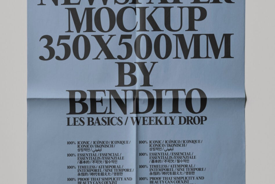 Folded newspaper close-up on blue background showing typography detail