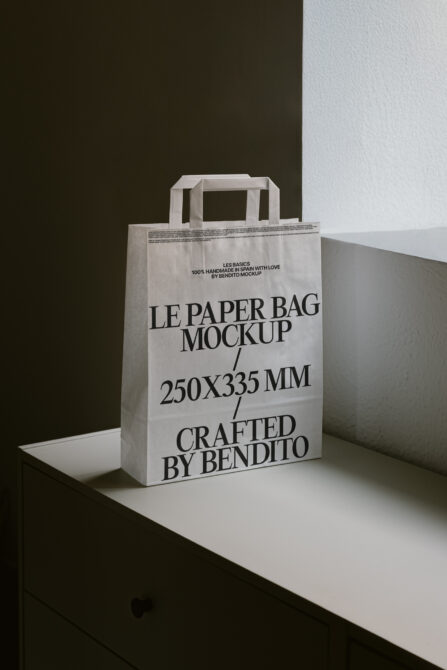 White paper shopping bag mockup with serif lettering, rope handles shown