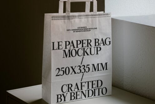 White paper bag with handles showing Les Basics branding text mockup