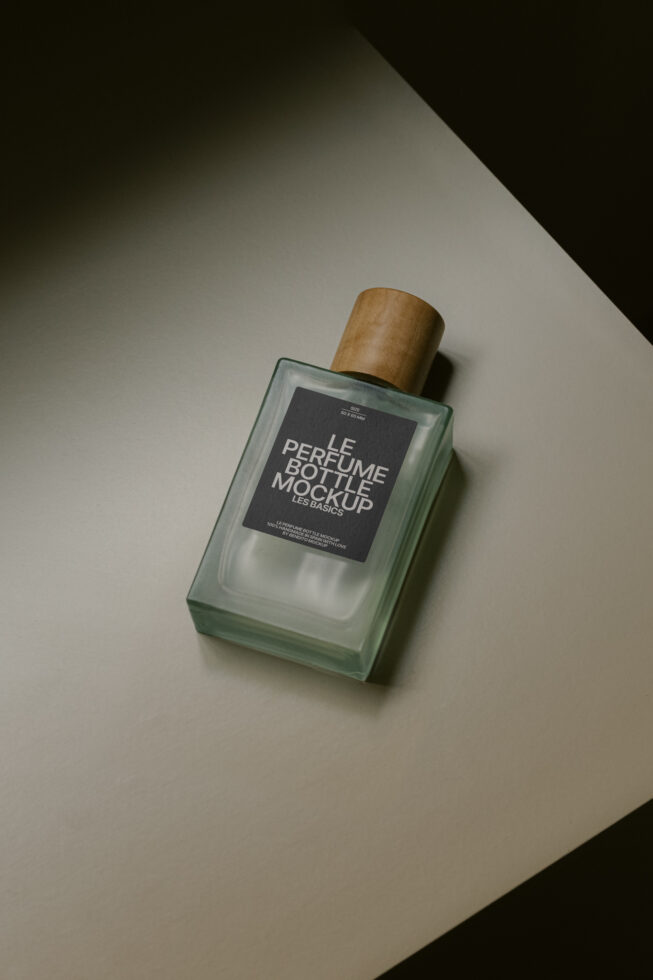 Elegant perfume bottle mockup featuring a frosted glass design with a wooden cap, perfect for branding presentations and product displays in graphics design.