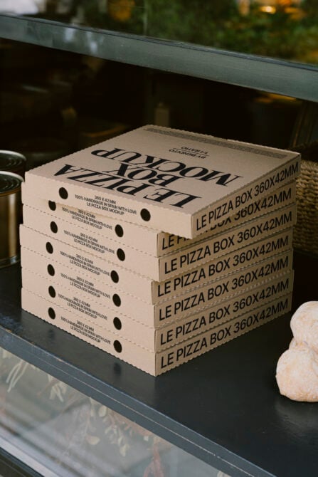 Stacked kraft pizza boxes 360x42mm with printed Le Pizza Box mockup branding