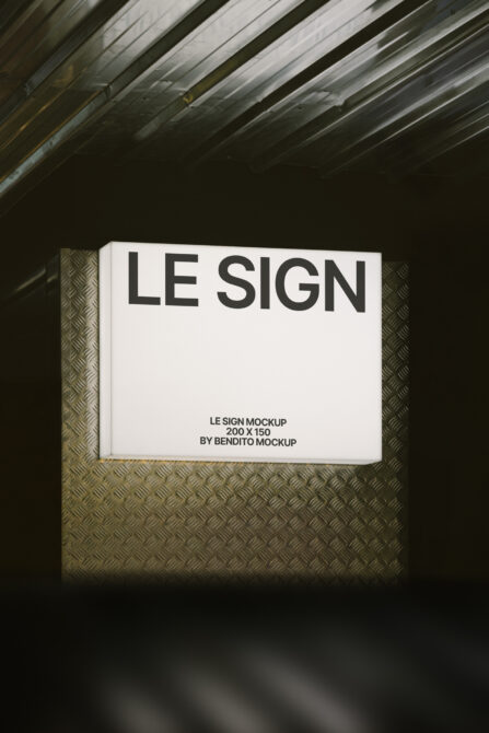 Framed sign mockup with cream background mounted on textured metal wall