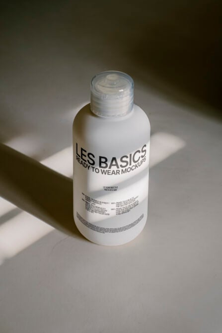 Clean white pump bottle mockup shot from above with sharp shadow detail
