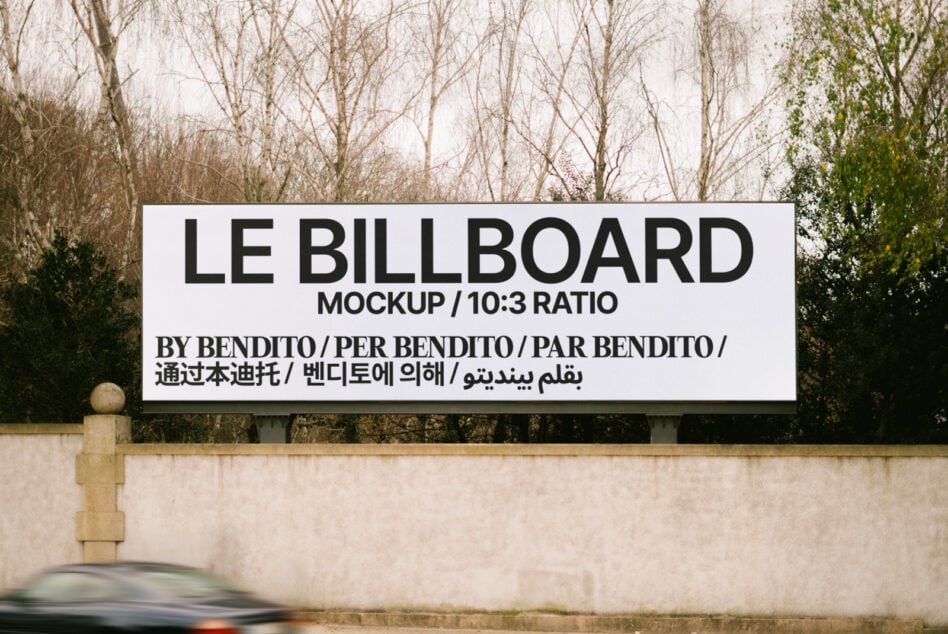 Horizontal roadside billboard with white background, black sans-serif text, bare trees behind